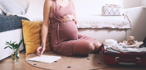 Une femme faisant une liste avant accouchement 